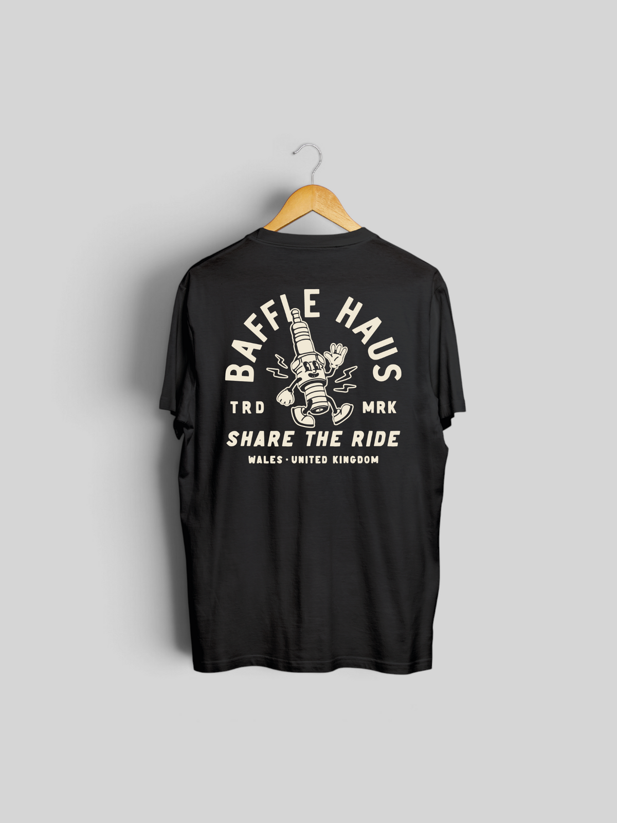 Baffle Haus black t-shirt featuring a vintage-style cartoon spark plug illustration on the back
