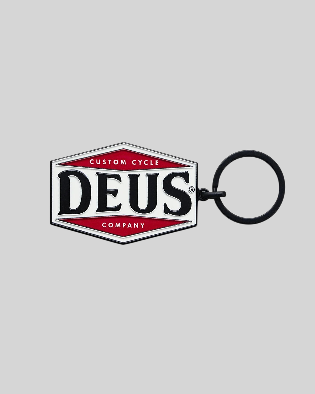 Baffle Haus Balsa key tag featuring a black, white, and red enamel Deus Custom Cycle Company logo on zinc alloy