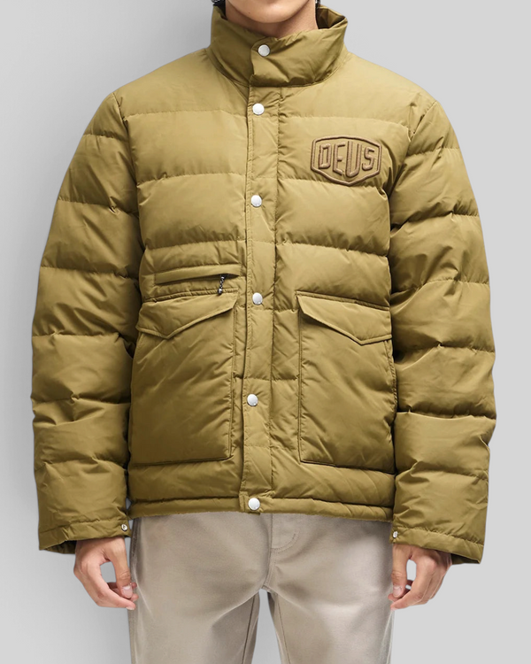 Baffle Haus Carson olive down jacket with chest branding, flap pockets, and snap button closure on a model