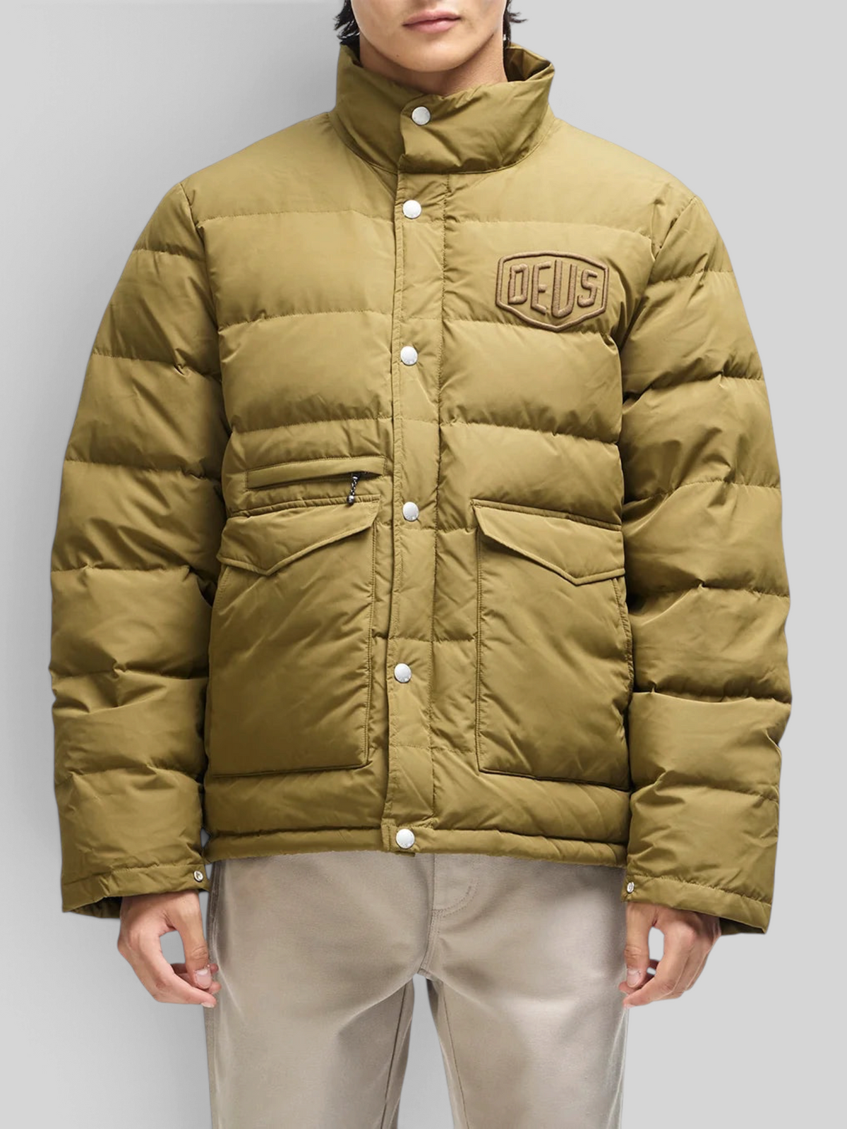 Baffle Haus Carson olive down jacket with chest branding, flap pockets, and snap button closure on a model