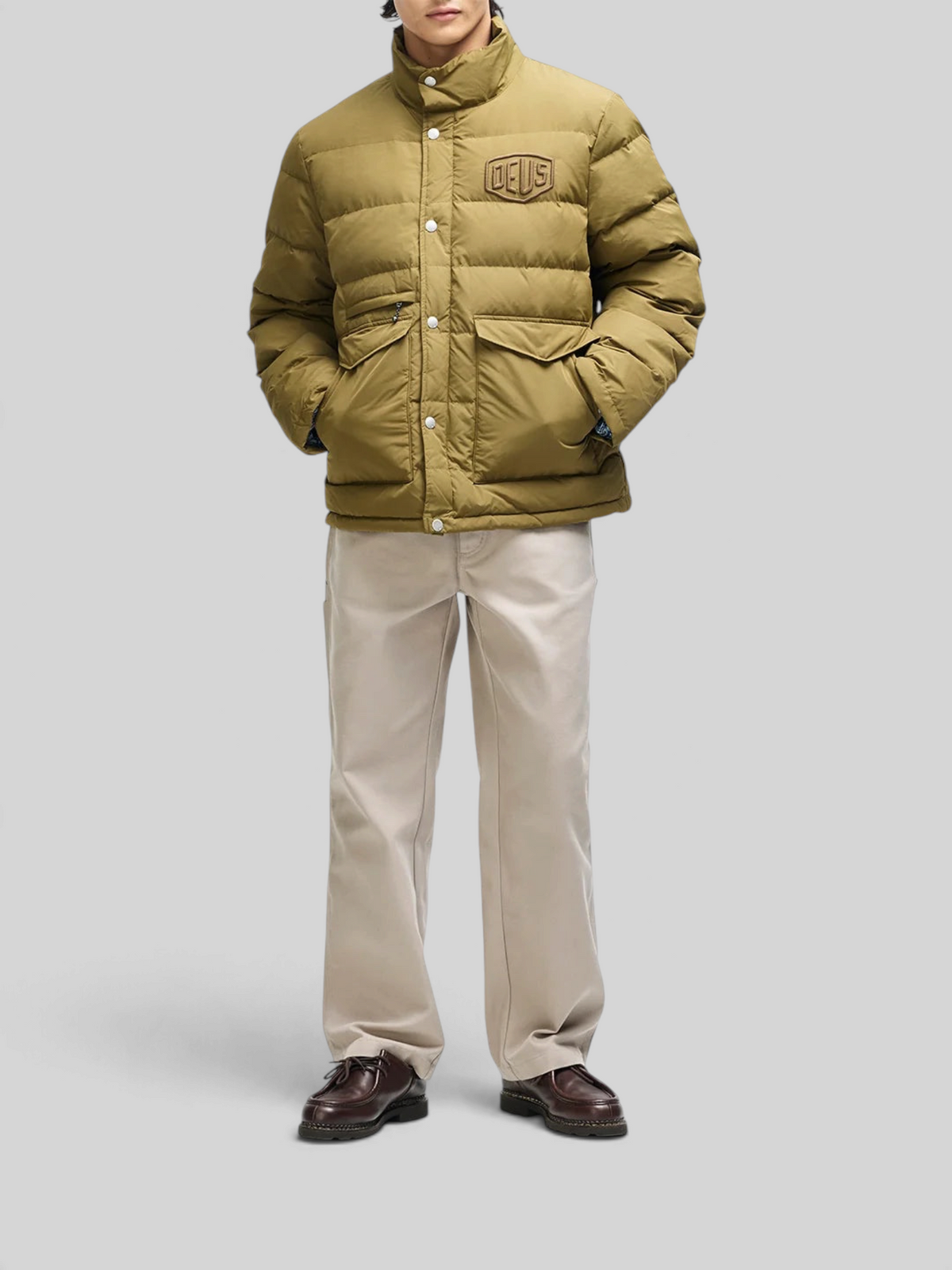 Baffle Haus Carson olive down jacket with high density chest branding, patch pockets, and snap placket closure.