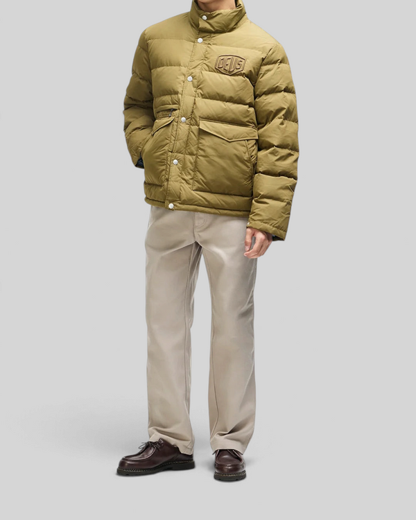 Baffle Haus Carson olive down jacket with high density chest branding, flap pockets, and snap placket on a model