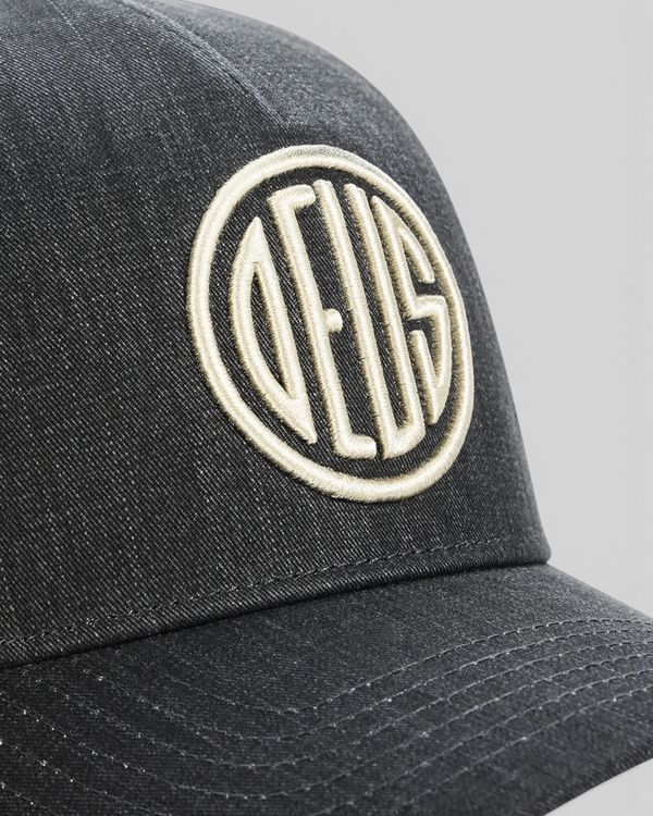 Baffle Haus black 5-panel cap featuring high-density embroidered circular logo detail on textured cotton twill