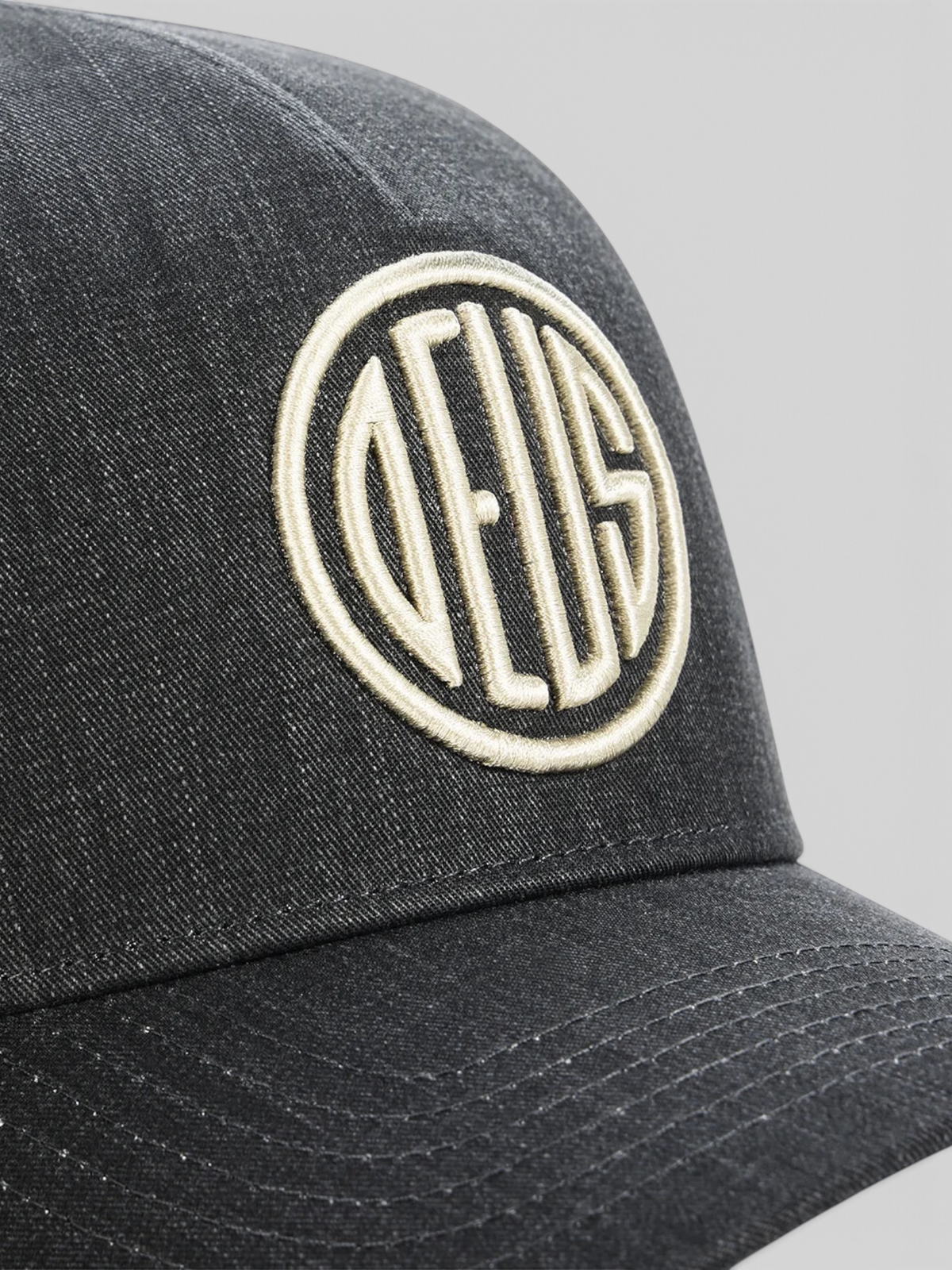 Baffle Haus black 5-panel cap featuring high-density embroidered circular logo detail on textured cotton twill
