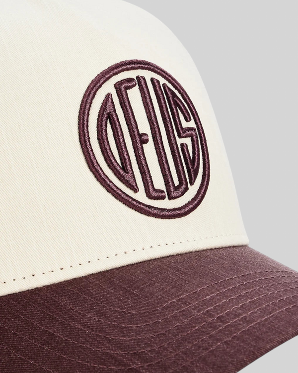 Baffle Haus 5-panel cap in cream and burgundy cotton twill with high-density embroidered circular logo detail