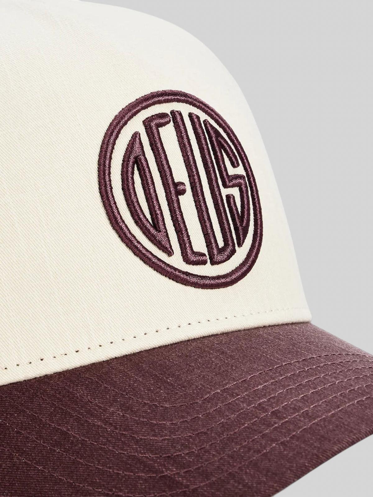 Baffle Haus 5-panel cap in cream and burgundy cotton twill with high-density embroidered circular logo detail