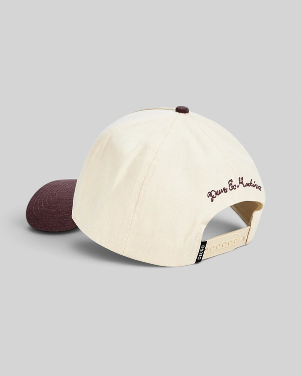 Baffle Haus 5-panel cap in cream cotton twill with a burgundy brim, top button, and rear embroidery.