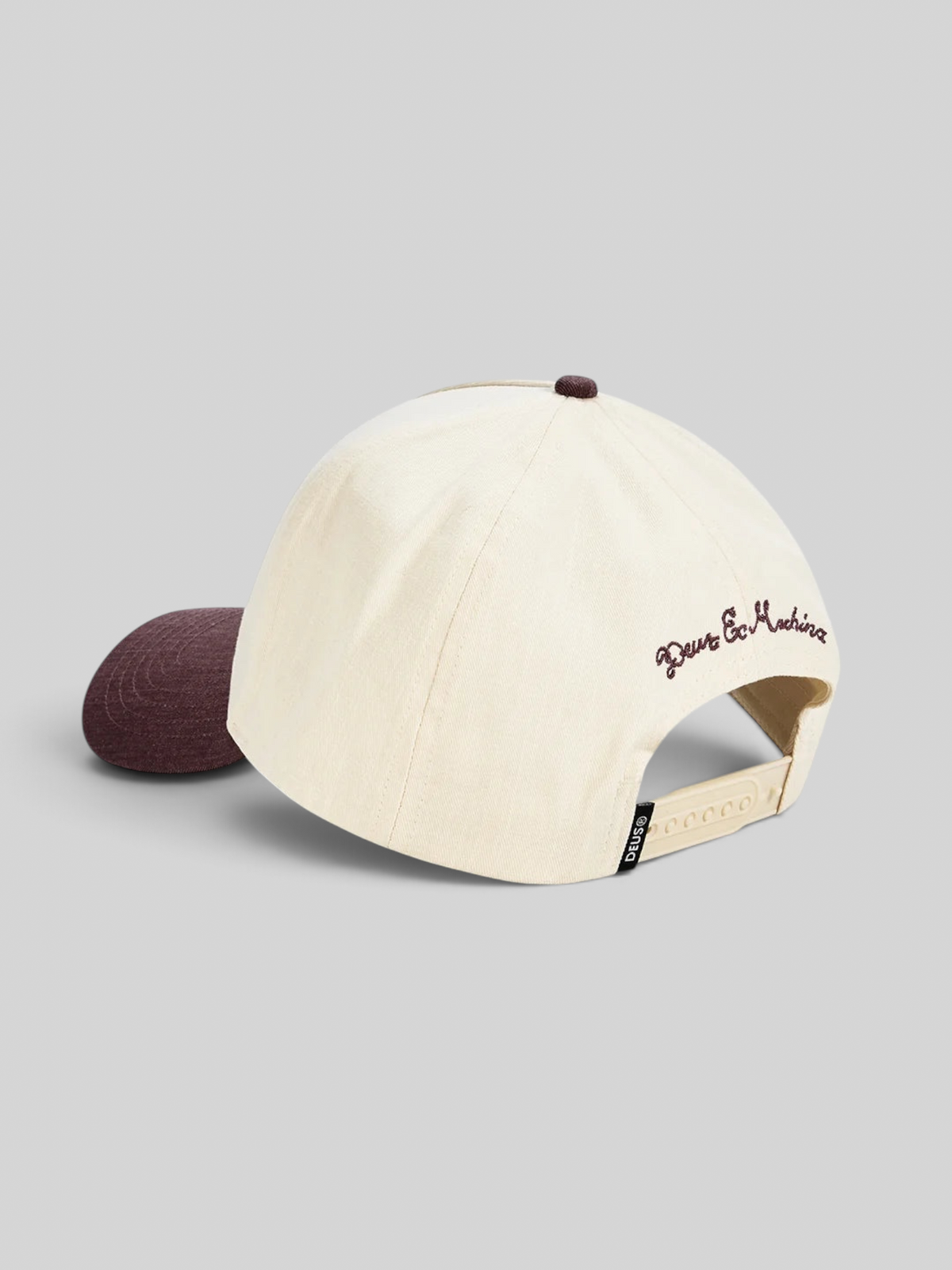 Baffle Haus 5-panel cap in cream cotton twill with a burgundy brim, top button, and rear embroidery.
