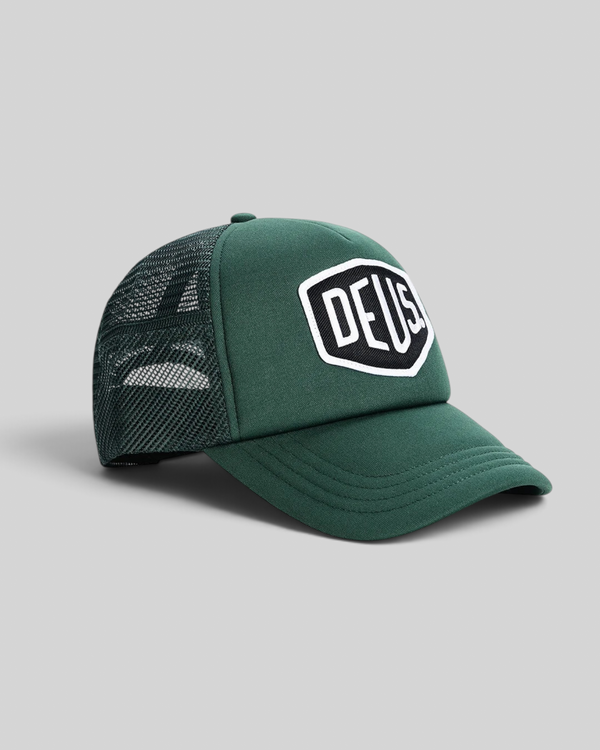 Baffle Haus Baylands trucker cap in racing green with black nylon mesh back and embroidered Deus logo patch