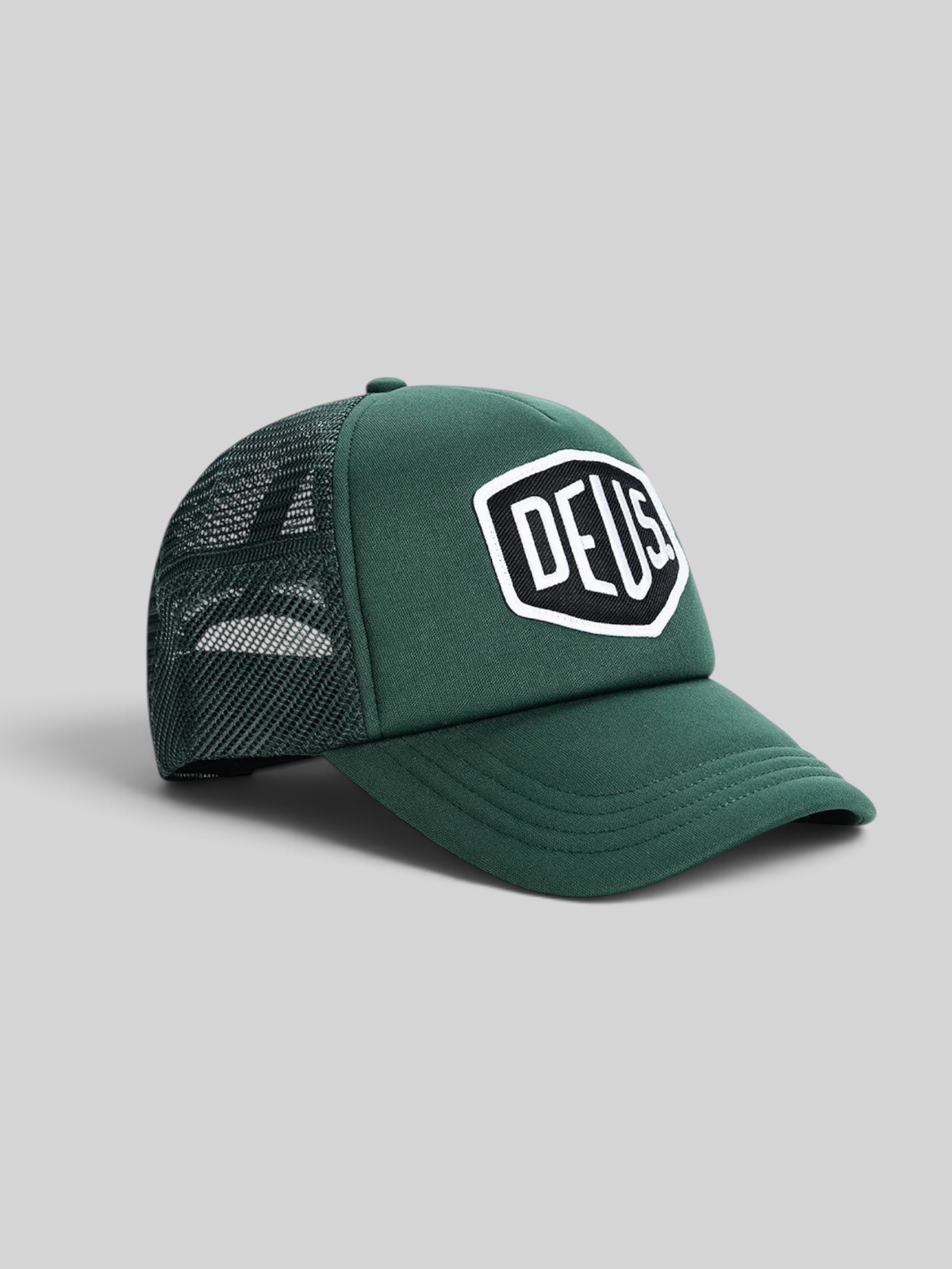 Baffle Haus Baylands trucker cap in racing green with black nylon mesh back and embroidered Deus logo patch