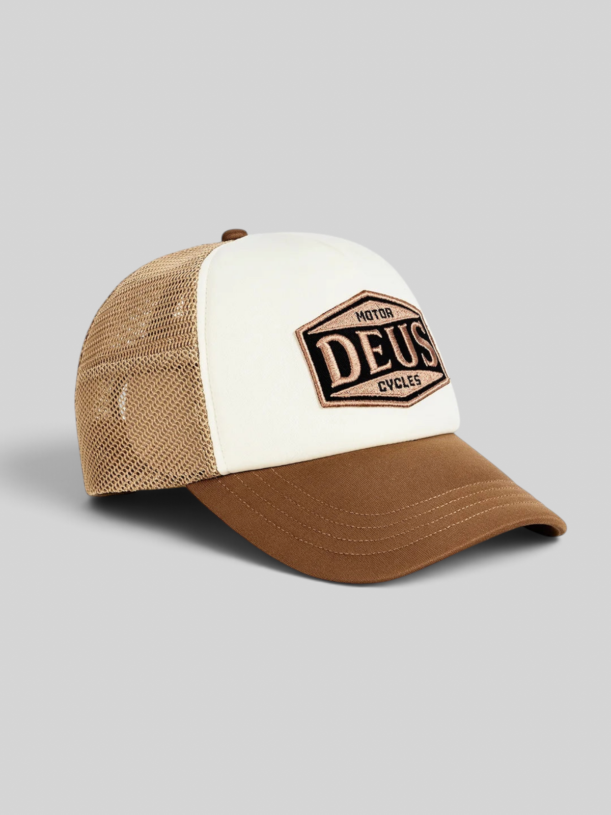 Baffle Haus Josel trucker hat in camel brown and white with a mesh back and embroidered Deus Motor Cycles badge.