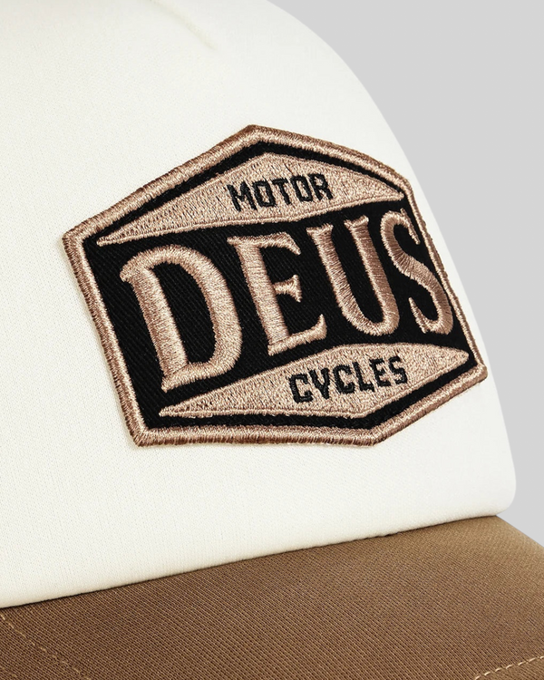 Baffle Haus Josel trucker cap in camel brown and white with an embroidered Deus Motor Cycles badge on the front
