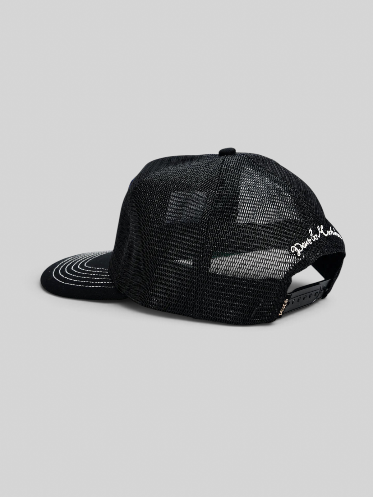 Baffle Haus black 5-panel trucker cap with polyester mesh back, snap adjuster, and white side embroidery