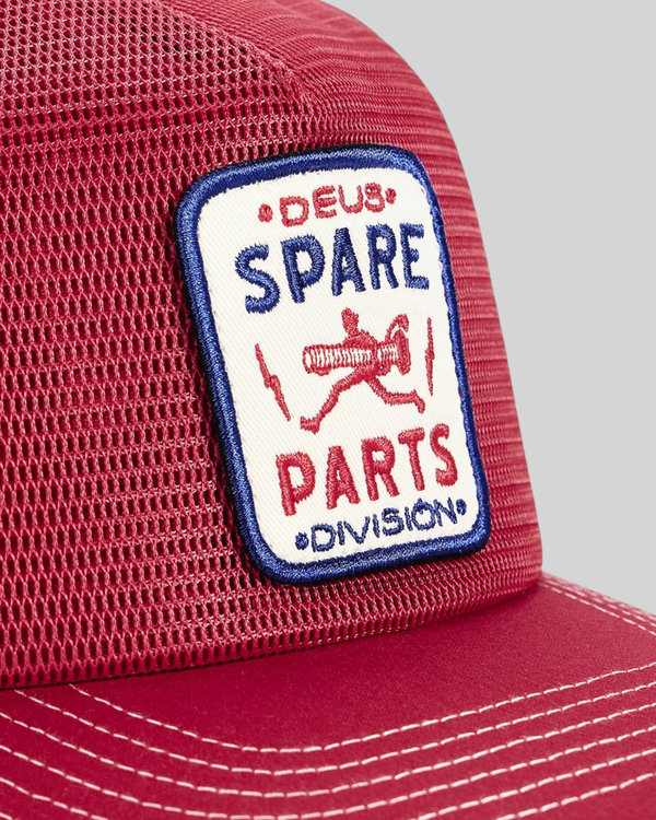 Baffle Haus Mudflap Trucker cap in cherry red with a detailed embroidered Spare Parts badge on the front mesh panel.