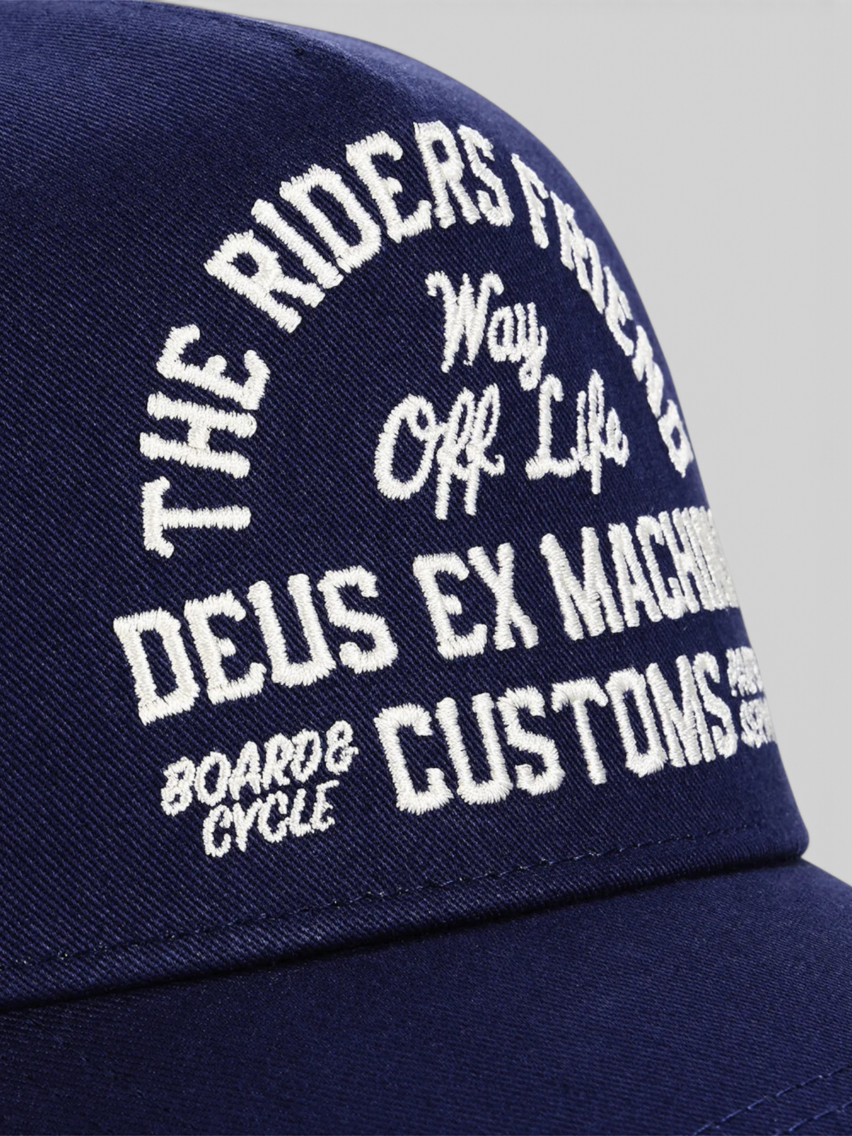 Baffle Haus Shook Ones trucker hat in mechanic blue with white embroidered graphic text on the front panel