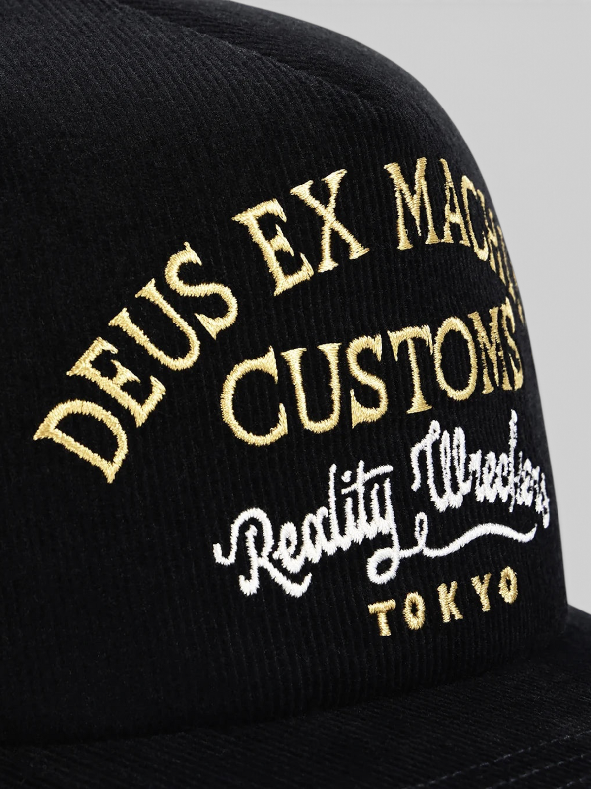 Baffle Haus Marsden black corduroy trucker cap with gold and white embroidered graphic detail on the front panel
