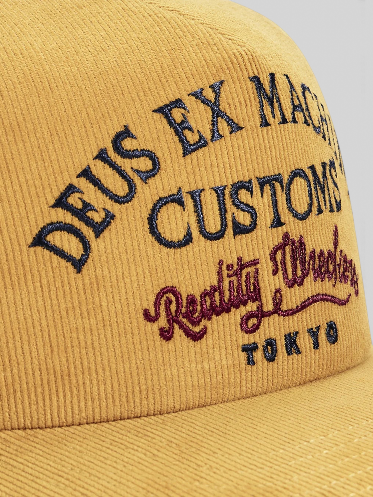 Baffle Haus Marsden Trucker cap in radiant yellow corduroy with detailed navy and burgundy front embroidery
