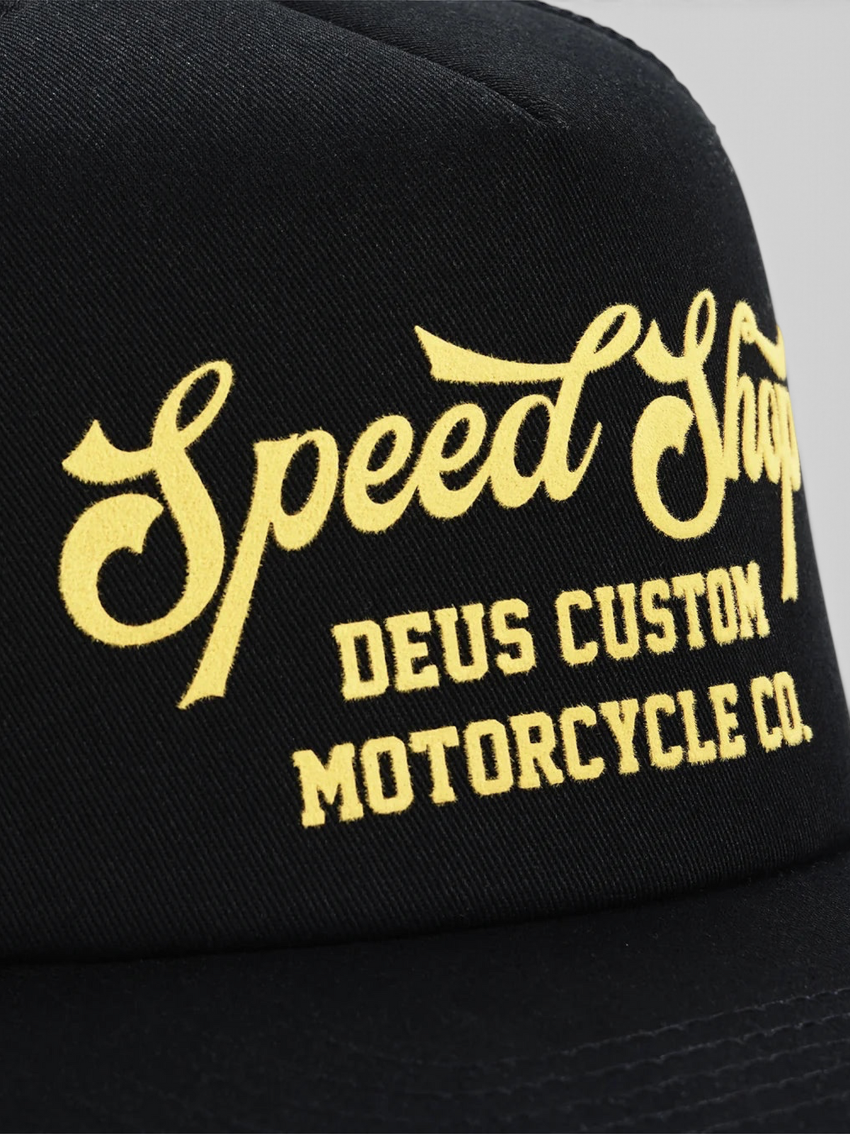 Baffle Haus Welcome Trucker cap in black with yellow flocked Speed Shop graphic on the front panel