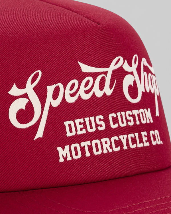 Baffle Haus Welcome Trucker cap in cherry red cotton twill with white flocked Speed Shop motorcycle graphic