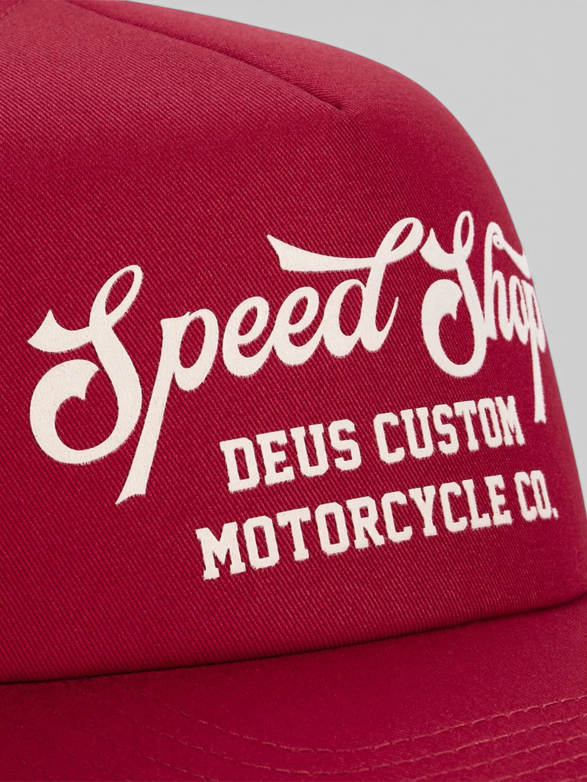 Baffle Haus Welcome Trucker cap in cherry red cotton twill with white flocked Speed Shop motorcycle graphic