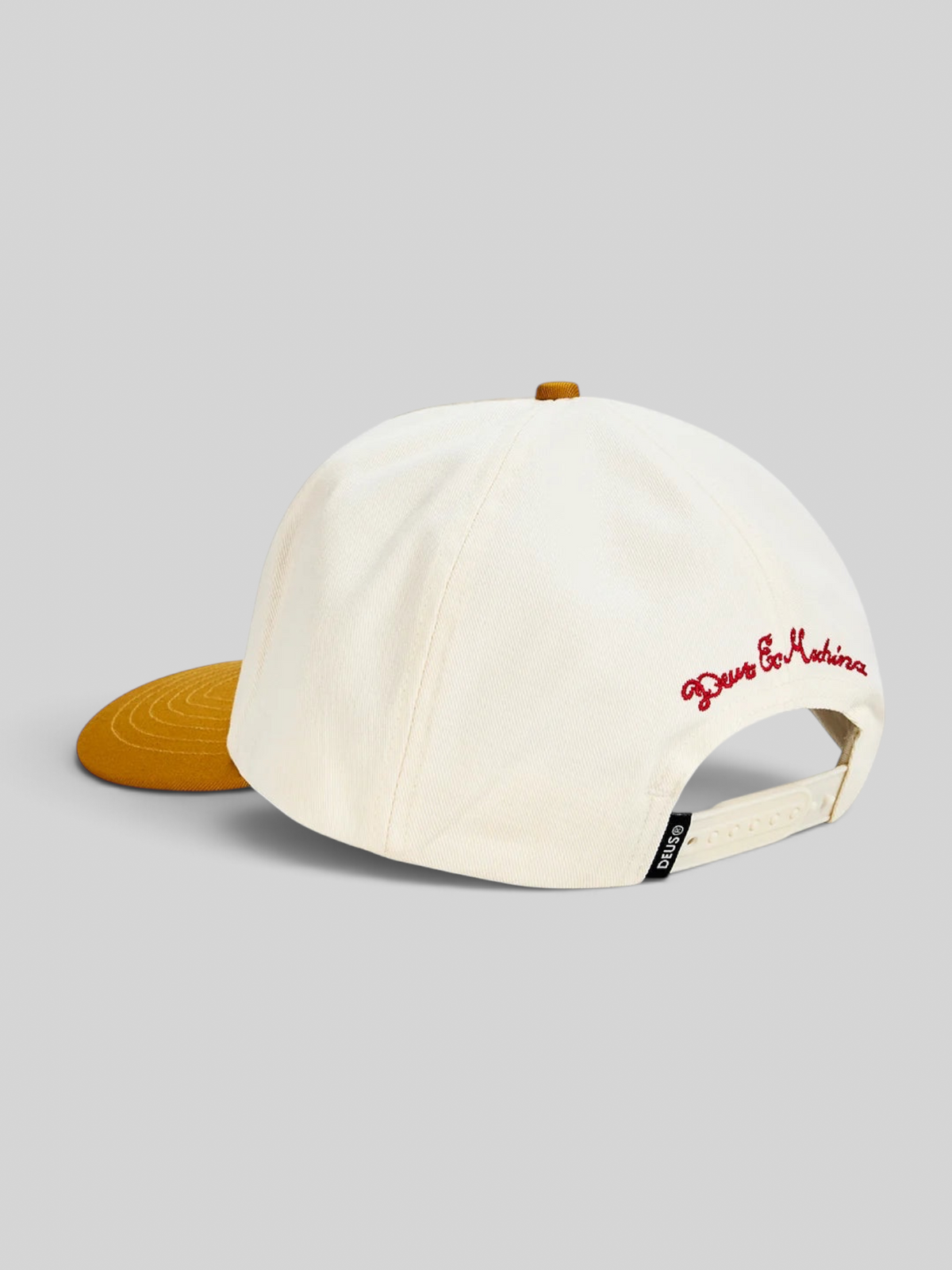 Baffle Haus Primo Cap in off-white cotton twill with a yellow brim, embroidered back detail, and plastic snap closure.