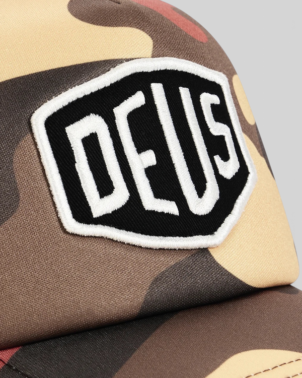 Baffle Haus Ombre Shield trucker cap in rust camo print with a black and white embroidered front badge