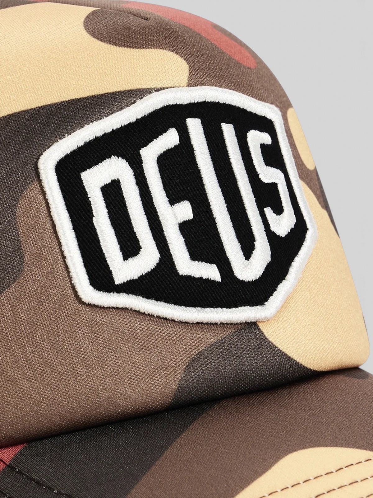 Baffle Haus Ombre Shield trucker cap in rust camo print with a black and white embroidered front badge