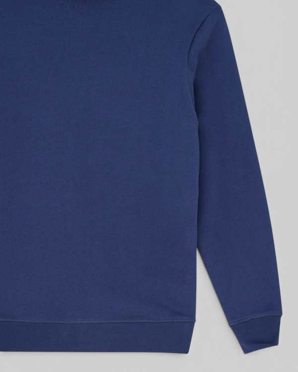 Baffle Haus Mudflap Hoodie in mechanic blue organic cotton fleece with ribbed cuffs and a boxy fit