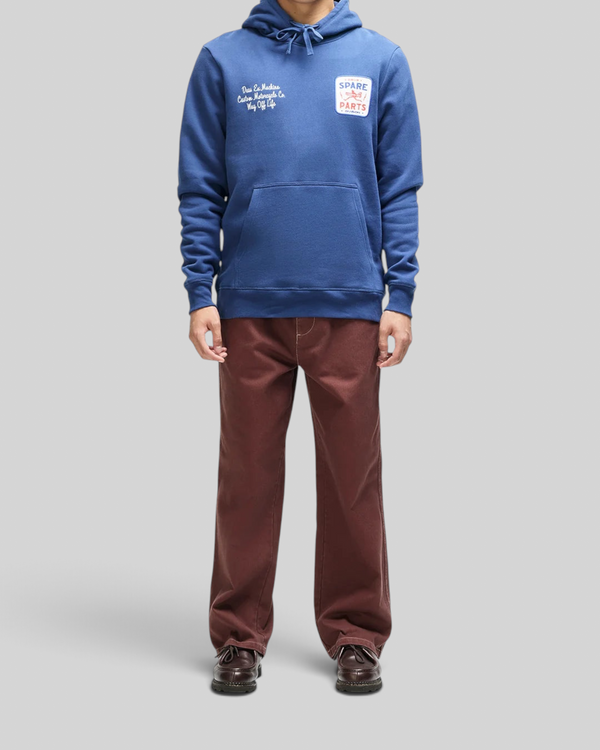 Baffle Haus Mudflap Hoodie in mechanic blue organic cotton fleece with embroidered chest art and kangaroo pocket.