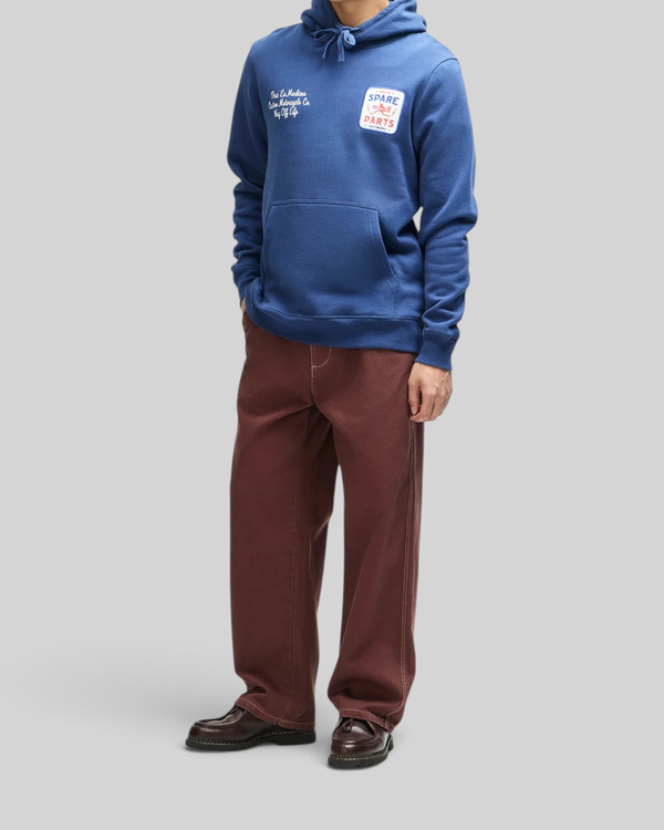 Baffle Haus Mudflap Hoodie in mechanic blue organic cotton fleece with chest embroidery and kangaroo pocket