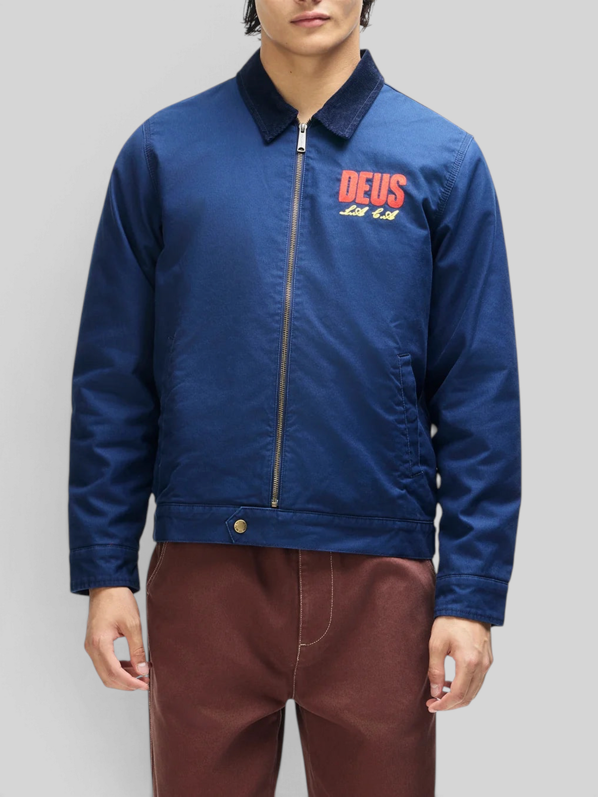Baffle Haus navy cotton whipcord cutaway jacket with zip front, corduroy collar, and embroidered chest logo