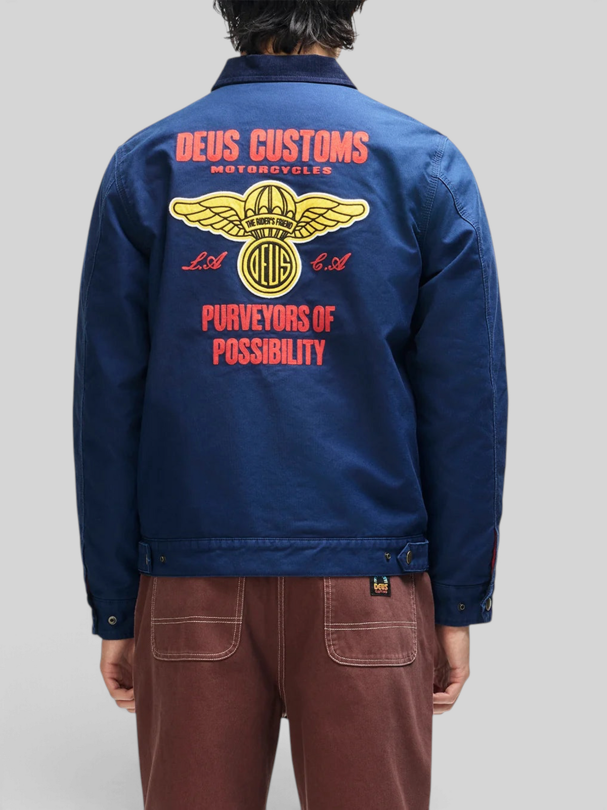 Baffle Haus navy cotton whipcord jacket with large yellow and red embroidered graphic on the back