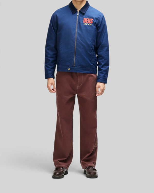 Baffle Haus navy cotton whipcord cutaway jacket with chest embroidery, zip front, and corduroy collar on a model