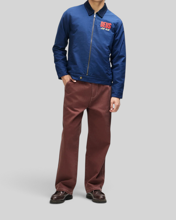 Baffle Haus navy cotton whipcord cutaway jacket with chest embroidery, zip front, and corduroy collar on a model