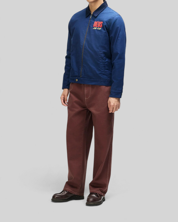 Baffle Haus navy cotton whipcord cutaway jacket with chest embroidery, zip front, and adjustable hem snaps