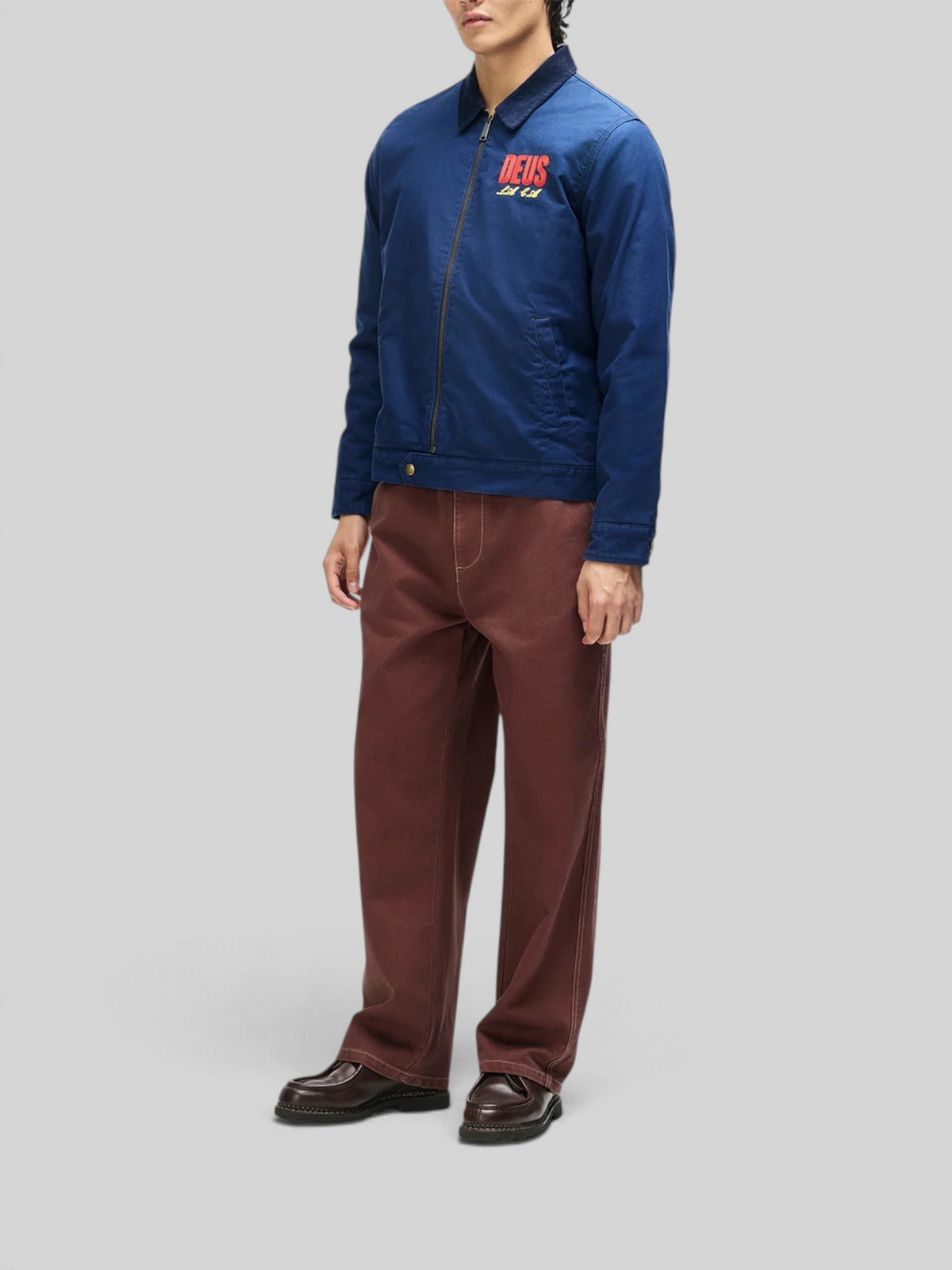 Baffle Haus navy cotton whipcord cutaway jacket with chest embroidery, zip front, and adjustable hem snaps