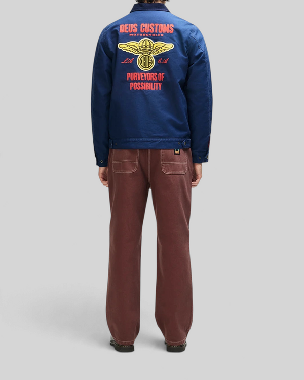 Baffle Haus navy cotton whipcord jacket with embroidered graphic art on the back, worn by a model from behind.