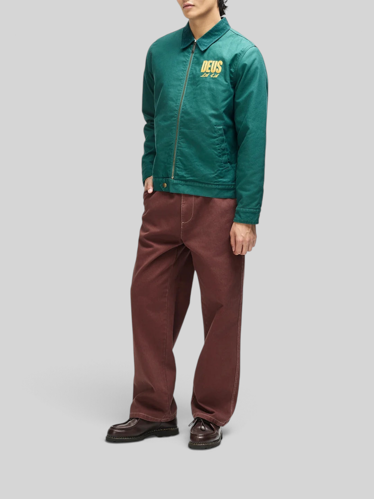 Baffle Haus racing green cotton whipcord jacket with zip front, embroidered chest logo, and adjustable hem snaps.