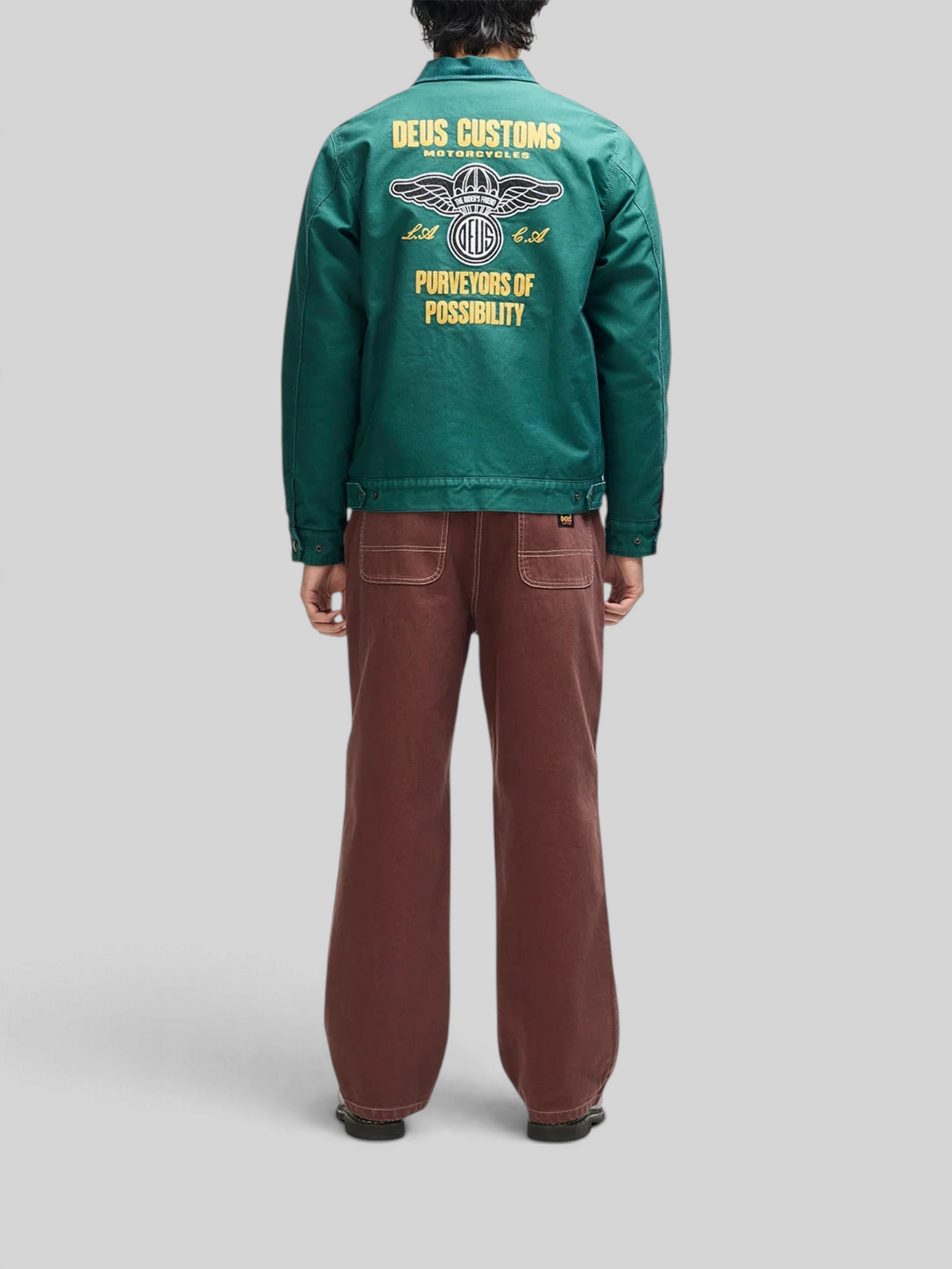 Baffle Haus racing green cotton whipcord cutaway jacket with yellow embroidered back graphic and zip front closure.