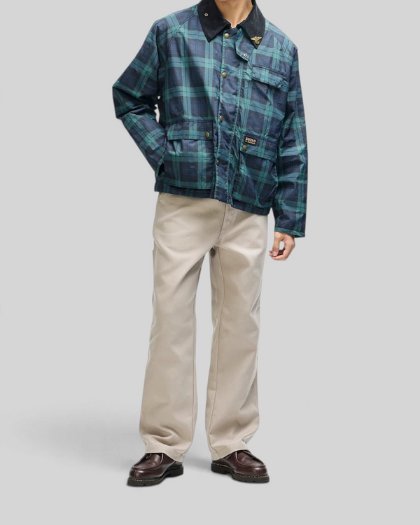 Baffle Haus Marsden hunting jacket in green check with corduroy collar, front pockets, and art pin detail.