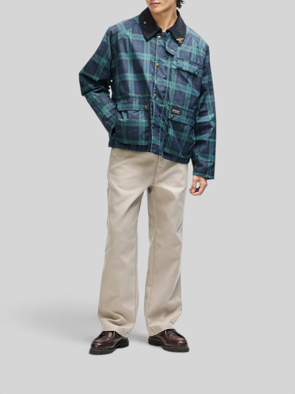 Baffle Haus Marsden hunting jacket in green check with corduroy collar, front pockets, and art pin detail.