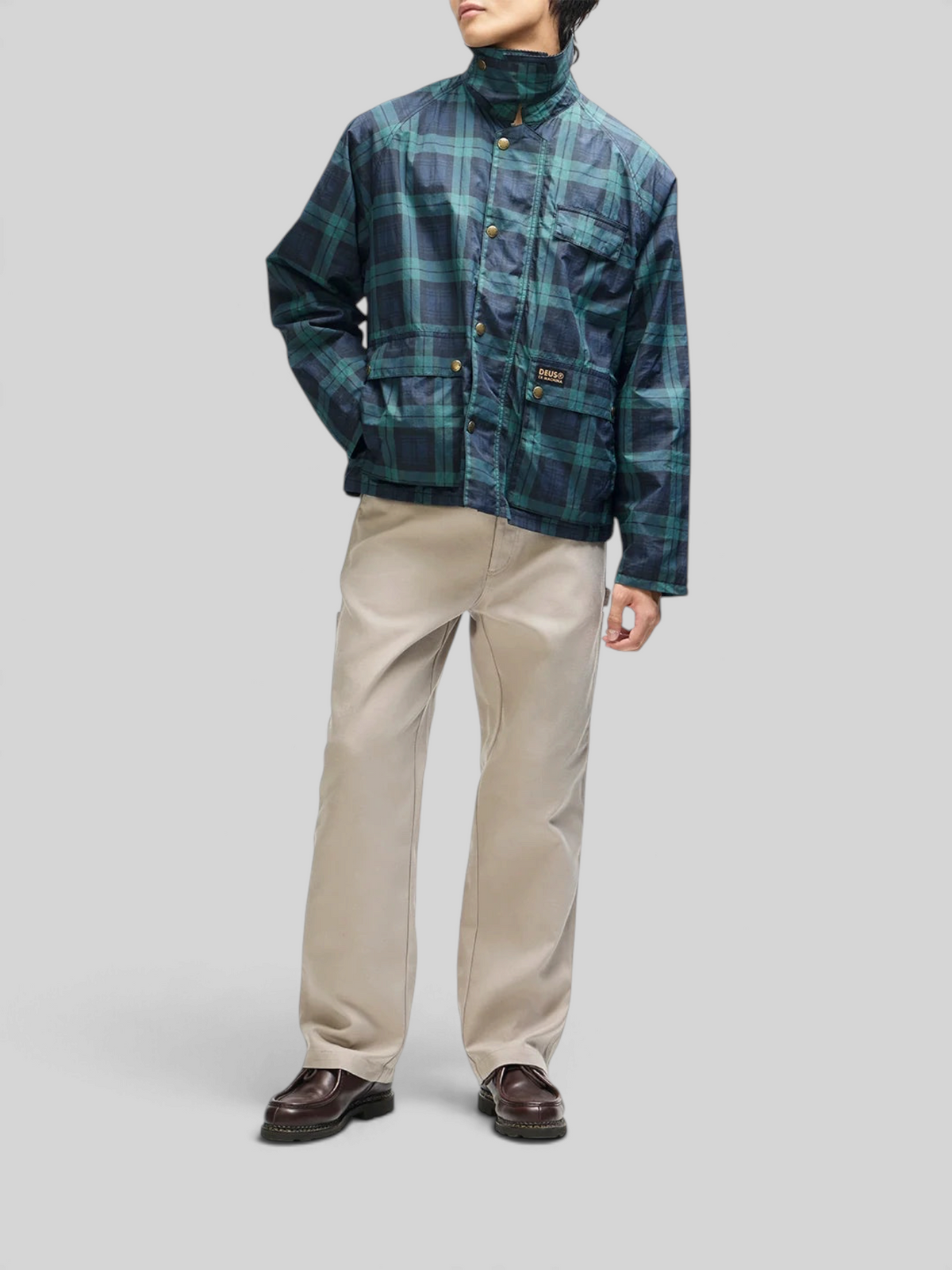 Baffle Haus Marsden hunting jacket in green check with corduroy collar, front pockets, and boxy fit on a model