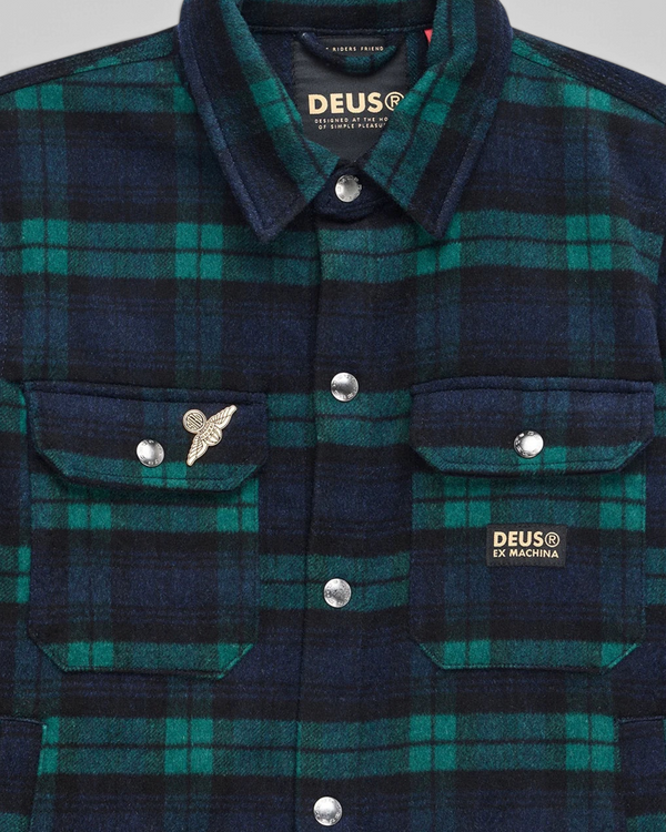 Baffle Haus Maxwell green and navy check wool-blend shirt with chest pockets, snap buttons, and metal pin detail.