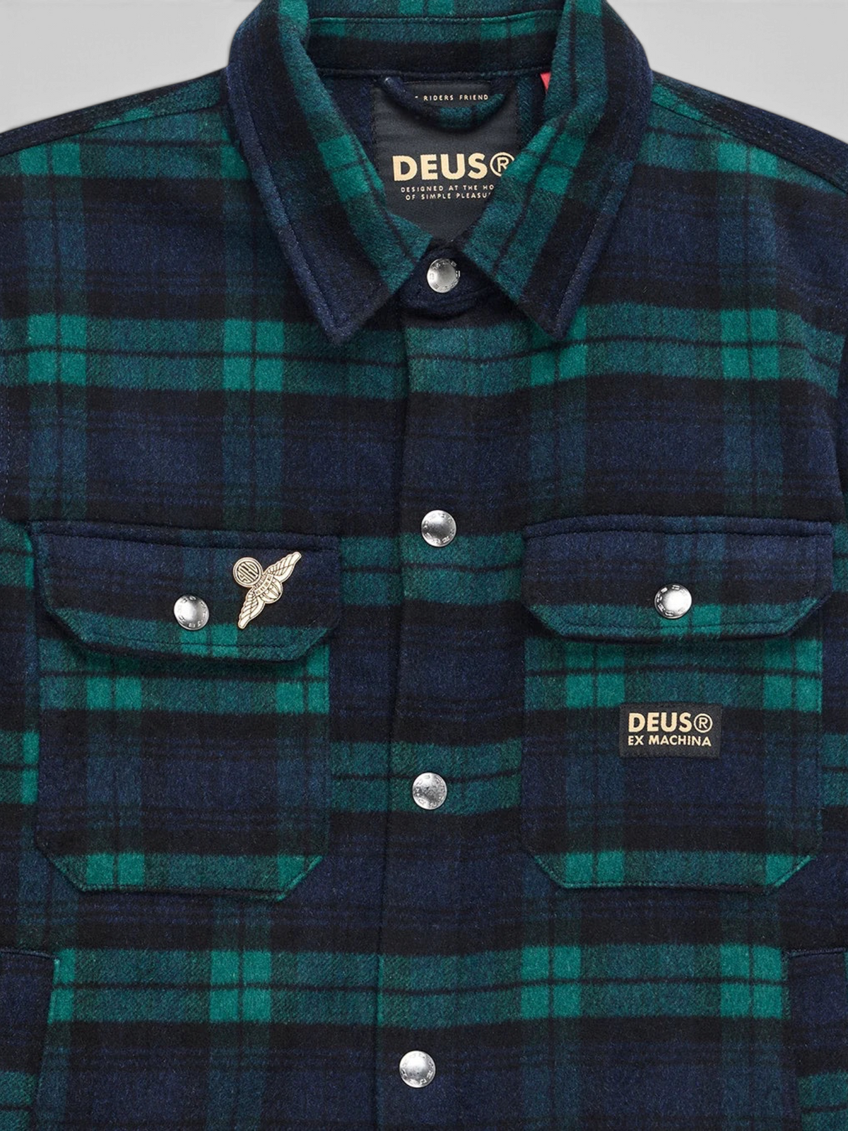 Baffle Haus Maxwell green and navy check wool-blend shirt with chest pockets, snap buttons, and metal pin detail.
