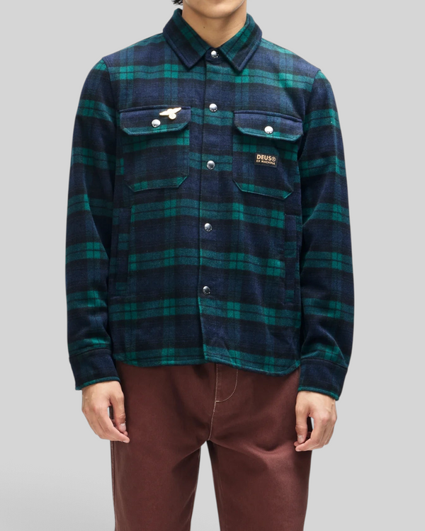 Baffle Haus Maxwell green and navy check wool blend shirt with chest pockets, snap buttons, and embroidered art pin.