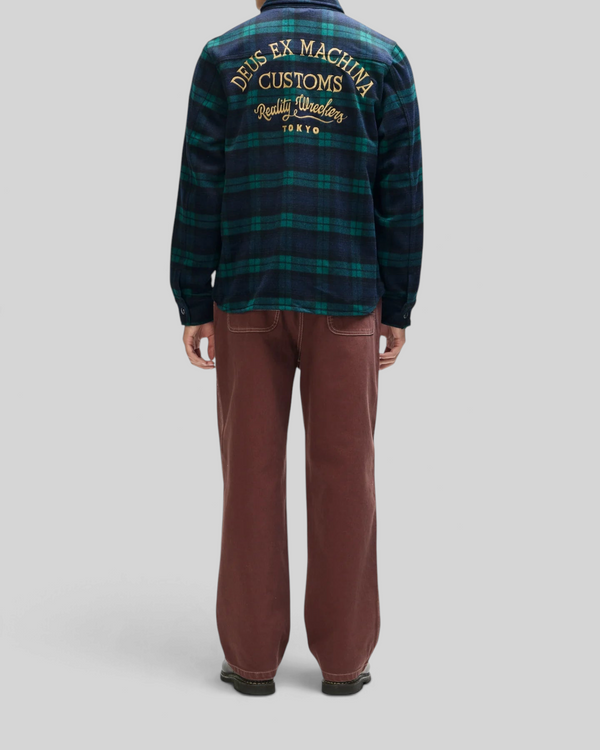 Baffle Haus Maxwell green check wool-blend shirt with back embroidery worn with brown trousers, rear view