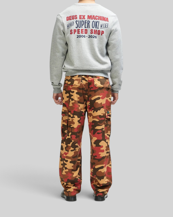 Baffle Haus grey marle crewneck sweatshirt with back graphic print paired with orange camouflage cargo pants