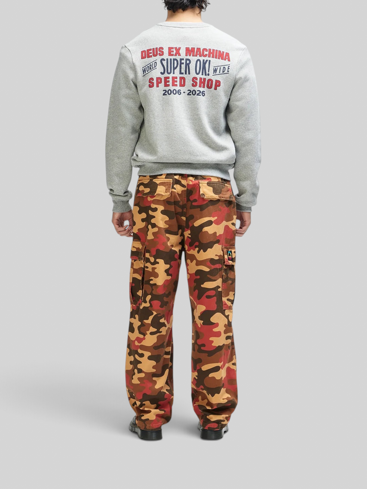 Baffle Haus grey marle crewneck sweatshirt with back graphic print paired with orange camouflage cargo pants