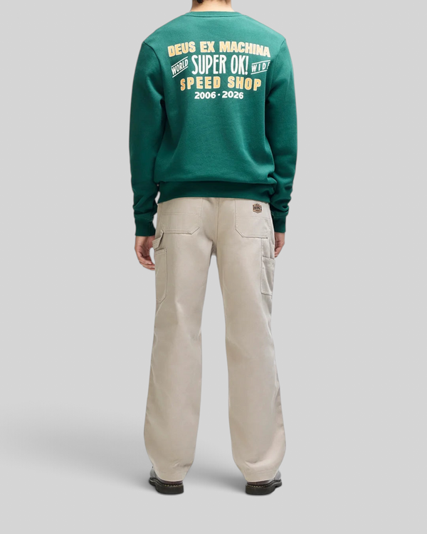 Baffle Haus Chessboxin Crew racing green sweatshirt with back graphic print paired with beige utility trousers