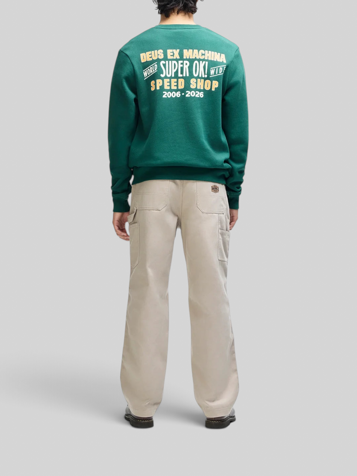 Baffle Haus Chessboxin Crew racing green sweatshirt with back graphic print paired with beige utility trousers